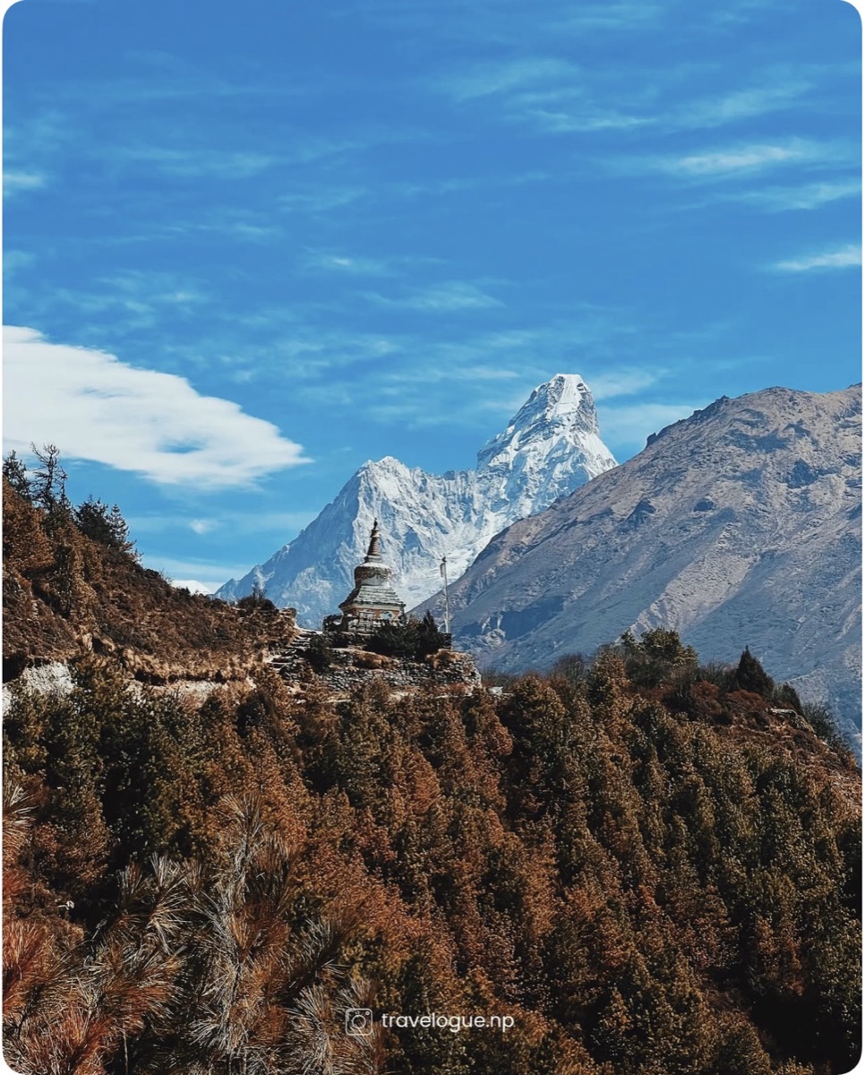 A Buddhist stupa on a ridge with Ama Dablam rising behind it, Khumbu region, Nepal
