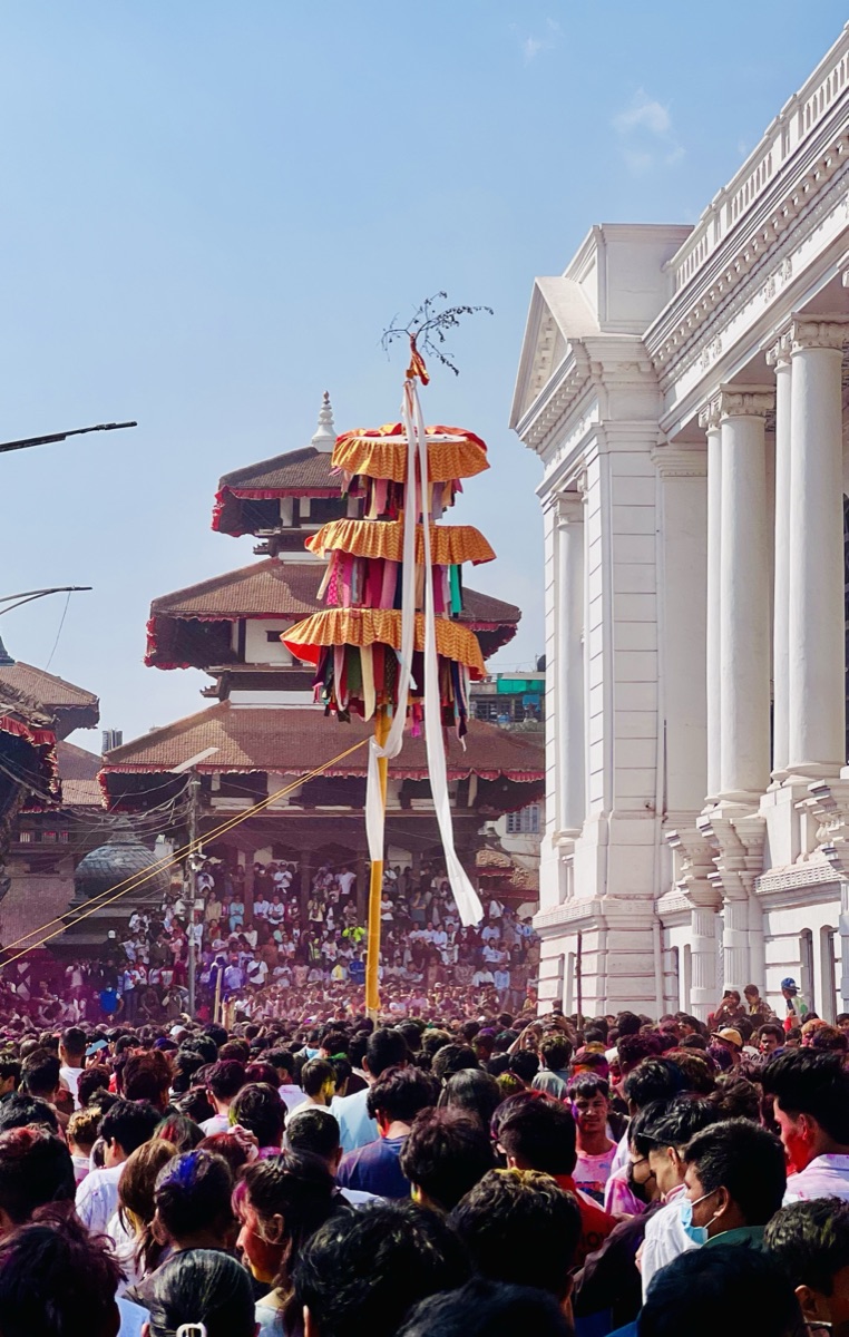 Holi festival crowd around the chir pole at Basantapur Durbar Square, Kathmandu