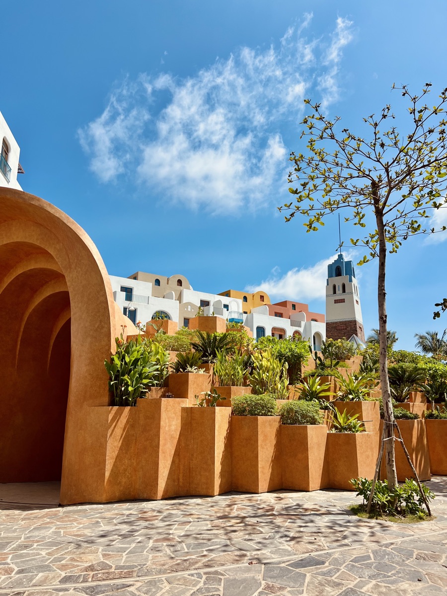 Terracotta arches and whitewashed Mediterranean-style buildings at a seaside resort